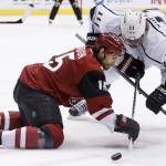 Arizona Coyotes' Boyd Gordon (15) beats Los Angeles Kings' Anze Kopitar (11), of Slovenia, to the puck during a face-off in the first period of an NHL hockey game Tuesday, Feb. 2, 2016, in Glendale, Ariz. (AP Photo/Ross D. Franklin)