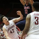 Arizona's Ryan Anderson (12) dunks against Washington State's Conor Clifford (42) during the second half of an NCAA college basketball game Wednesday, Feb. 3, 2016, in Pullman, Wash. Arizona won 79-64. (AP Photo/Young Kwak)