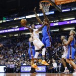 Phoenix Suns' Archie Goodwin tries to get off a shot over Oklahoma City Thunder's Serge Ibaka (9), of the Congo, as Suns' Sonny Weems, left, P.J. Tucker, second from right, and Kyle Singler (5) all watch during the second half of an NBA basketball game Monday, Feb. 8, 2016, in Phoenix.  The Thunder defeated the Suns 122-106. (AP Photo/Ross D. Franklin)