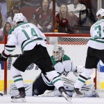 Dallas Stars goalie Antti Niemi, middle, of Finland, slides over to make a save on a shot by the Arizona Coyotes as Stars' Jamie Benn (14) and John Klingberg (3), of Sweden, watch during the first period of an NHL hockey game Thursday, Feb. 18, 2016, in Glendale, Ariz. (AP Photo/Ross D. Franklin)