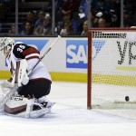 Arizona Coyotes goalie Louis Domingue is beaten for a goal on a shot from San Jose Sharks' Matt Tennyson during the first period of an NHL hockey game Saturday, Feb. 13, 2016, in San Jose, Calif. (AP Photo/Marcio Jose Sanchez)