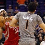 Houston Rockets guard Corey Brewer (33) is fouled by Phoenix Suns guard Devin Booker during the third quarter of an NBA basketball game, Thursday, Feb. 4, 2016, in Phoenix. The Rockets won 111-105. (AP Photo/Rick Scuteri)