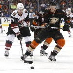 Arizona Coyotes right wing Shane Doan (19), left, and Anaheim Ducks defenseman Josh Manson (42) chase the puck in the first period of an NHL hockey game in Anaheim, Calif., Friday, Feb. 5, 2016. (AP Photo/Christine Cotter)