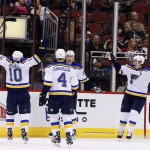St. Louis Blues' Patrik Berglund (21), of Sweden, celebrates his goal against the Arizona Coyotes with Scottie Upshall (10), Carl Gunnarsson (4), of Sweden, and David Backes, right, during the third period of an NHL hockey game Saturday, Feb. 20, 2016, in Glendale, Ariz. The Blues defeated the Coyotes 6-4. (AP Photo/Ross D. Franklin)