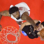 Phoenix Suns guard Devin Booker, right, shoots as Los Angeles Clippers center DeAndre Jordan defends during the first half of an NBA basketball game, Monday, Feb. 22, 2016, in  Los Angeles. (AP Photo/Mark J. Terrill)