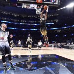 World forward Andrew Wiggins (22) slam-dunks the ball past U.S. guard Zach LaVine during the first half of the NBA Rising Stars Challenge basketball game in Toronto, Friday, Feb. 12, 2016. (Bob Donna/The Canadian Press via AP, Pool) MANDATORY CREDIT