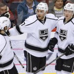 Los Angeles Kings' Alec Martinez (27) celebrates his goal against the Arizona Coyotes with Drew Doughty (8) and Tyler Toffoli (73) during the second period of an NHL hockey game Tuesday, Feb. 2, 2016, in Glendale, Ariz. (AP Photo/Ross D. Franklin)