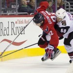 Arizona Coyotes center Antoine Vermette (50) and Washington Capitals center Evgeny Kuznetsov (92) fight for control of the puck during the second period of an NHL hockey game, on Monday, Feb. 22, 2016, in Washington. (AP Photo/Evan Vucci)