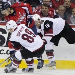 Arizona Coyotes left wing Mikkel Boedker (89) and right wing Shane Doan (19) defend against Washington Capitals defenseman John Carlson (74) during the first period of an NHL hockey game on Monday, Feb. 22, 2016, in Washington. (AP Photo/Evan Vucci)