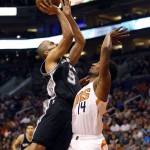 San Antonio Spurs guard Tony Parker shoots over Phoenix Suns guard Ronnie Price (14) in the fourth quarter of an NBA basketball game, Sunday, Feb. 21, 2016, in Phoenix. The Spurs won 118-111. (AP Photo/Rick Scuteri)