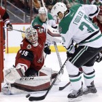 Arizona Coyotes' Louis Domingue (35) reaches over to make a save on a shot by Dallas Stars' Vernon Fiddler, right, as Stars' Colton Sceviour (22) watches during the first period of an NHL hockey game Thursday, Feb. 18, 2016, in Glendale, Ariz. (AP Photo/Ross D. Franklin)