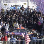 Denny Hamlin (11), center, celebrates in Victory Lane after winning the NASCAR Daytona 500 Sprint Cup series auto race at Daytona International Speedway, Sunday, Feb. 21, 2016, in Daytona Beach, Fla. (AP Photo/Phelan M. Ebenhack)