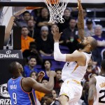 Phoenix Suns' Tyson Chandler, right, scores against Oklahoma City Thunder's Serge Ibaka (9), of the Congo, during the first half of an NBA basketball game Monday, Feb. 8, 2016, in Phoenix. (AP Photo/Ross D. Franklin)