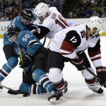 San Jose Sharks center Chris Tierney (50) gets tangled with teammate Melker Karlsson (68) and Arizona Coyotes' Max Domi (16) and Brad Richardson (12) during a face-off in the first period of an NHL hockey game Saturday, Feb. 13, 2016, in San Jose, Calif. (AP Photo/Marcio Jose Sanchez)