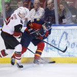 Florida Panthers left wing Jussi Jokinen (36) goes down after being hit in the mouth by a stick, as he battles for the puck with Arizona Coyotes defenseman Connor Murphy (5) during the first period of an NHL hockey game, Thursday, Feb. 25, 2016 in Sunrise, Fla. (AP Photo/Wilfredo Lee)
