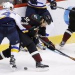 Arizona Coyotes' Antoine Vermette (50) battles with St. Louis Blues' Carl Gunnarsson (4), of Sweden, for the puck during the second period of an NHL hockey game Saturday, Feb. 20, 2016, in Glendale, Ariz. (AP Photo/Ross D. Franklin)