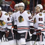 Chicago Blackhawks' Marian Hossa (81), of the Czech Republic, smiles as he celebrates his goal against the Arizona Coyotes with teammates Erik Gustafsson (52), of Sweden, Andrew Shaw (65), Brent Seabrook (7) and Jonathan Toews during the second period of an NHL hockey game Thursday, Feb. 4, 2016, in Glendale, Ariz. (AP Photo/Ross D. Franklin)