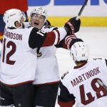 Arizona Coyotes right wing Shane Doan, center, celebrates with right wing Brad Richardson (12) and left wing Jordan Martinook (48) after Doan scored during the first period of an NHL hockey game against the Florida Panthers, Thursday, Feb. 25, 2016 in Sunrise, Fla. (AP Photo/Wilfredo Lee)