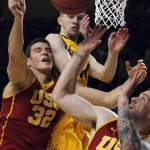 Southern California's Nikola Jovanovic (32) and Kating Reinhardt (5) battle for a rebound against Arizona State guard Kodi Justice during the second half of an NCAA college basketball game in Tempe, Ariz., Friday, Feb. 12, 2016. Arizona State defeated USC 74-67. (AP Photo/Ricardo Arduengo)