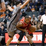Houston Rockets forward Trevor Ariza (1) drives on Phoenix Suns guard Devin Booker during the second quarter of an NBA basketball game Thursday, Feb. 4, 2016, in Phoenix. (AP Photo/Rick Scuteri)