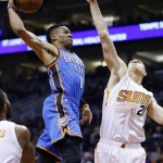 Oklahoma City Thunder's Russell Westbrook (0) drives past Phoenix Suns' Alex Len (21), of Ukraine, for a dunk during the first half of an NBA basketball game Monday, Feb. 8, 2016, in Phoenix. (AP Photo/Ross D. Franklin)