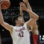 Washington State's Conor Clifford (42) shoots against Arizona's Dusan Ristic during the first half of an NCAA college basketball game, Wednesday, Feb. 3, 2016, in Pullman, Wash. (AP Photo/Young Kwak)