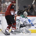 Dallas Stars' Antti Niemi (31), of Finland, makes a save on a shot as Arizona Coyotes' Martin Hanzal (11), of the Czech Republic, and Stars' Jordie Benn, left, watch during the first period of an NHL hockey game Thursday, Feb. 18, 2016, in Glendale, Ariz. (AP Photo/Ross D. Franklin)