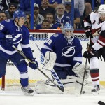 Arizona Coyotes' Martin Hanzal, of Czech Republic, tries to tip a puck past the defense of Tampa Bay Lightning's Matt Carle (25) and goalie Andrei Vasilevskiy, of Russia, during the second period of an NHL hockey game Tuesday, Feb. 23, 2016, in Tampa, Fla. (AP Photo/Mike Carlson)