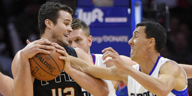 Los Angeles Clippers guard Pablo Prigioni, of Argentina, reaches in on Phoenix Suns forward Kris Hu...