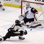 Pittsburgh Penguins' Nick Bonino (13) can't get a shot past Arizona Coyotes goalie Louis Domingue (35) during the first period of an NHL hockey game in Pittsburgh, Monday, Feb. 29, 2016. (AP Photo/Gene J. Puskar)