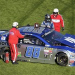Dale Earnhardt Jr. (88) is helped out of his car after hitting an interior wall as he was losing control of his car, coming out of Turn 4 during the NASCAR Daytona 500 Sprint Cup series auto race at Daytona International Speedway, Sunday, Feb. 21, 2016, in Daytona Beach, Fla. (AP Photo/Phelan M. Ebenhack)