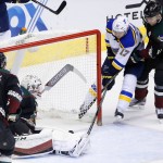 St. Louis Blues' Jaden Schwartz (17) scores a goal against Arizona Coyotes' Louis Domingue, second from left, as Coyotes' Martin Hanzal, right, of the Czech Republic, defends and Coyotes' Jordan Martinook (48) watches during the first period of an NHL hockey game Saturday, Feb. 20, 2016, in Glendale, Ariz. (AP Photo/Ross D. Franklin)
