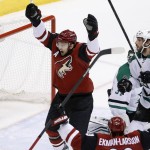Arizona Coyotes' Martin Hanzal, left, of the Czech Republic, and Oliver Ekman-Larsson, bottom right, celebrate a goal by Michael Stone as Dallas Stars' Jason Demers (4) and goalie Antti Niemi, back right, look for the puck during the second period of an NHL hockey game Thursday, Feb. 18, 2016, in Glendale, Ariz. (AP Photo/Ross D. Franklin)