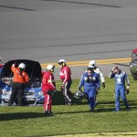 Dale Earnhardt Jr., second from right, heads to an ambulance after spinning out during the NASCAR Daytona 500 auto race at Daytona International Speedway, Sunday, Feb. 21, 2016 in Daytona Beach, Fla. (AP Photo/Wilfredo Lee)