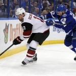 Arizona Coyotes' Brad Richardson is checked by Tampa Bay Lightning's Nikita Nesterov, of Russia, during the first period of an NHL hockey game Tuesday, Feb. 23, 2016, in Tampa, Fla. (AP Photo/Mike Carlson)