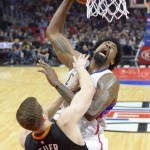 Los Angeles Clippers center DeAndre Jordan, top, shoots as Phoenix Suns forward Jon Leuer defends during the first half of an NBA basketball game, Monday, Feb. 22, 2016, in  Los Angeles. (AP Photo/Mark J. Terrill)