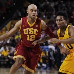 Southern California guard Julian Jacobs (16) dribbles the ball against Arizona State guard Tra Holder during the second half of an NCAA college basketball game in Tempe, Ariz., Friday, Feb. 12, 2016. Arizona State defeated USC 74-67. (AP Photo/Ricardo Arduengo)