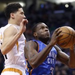 Oklahoma City Thunder's Dion Waiters (3) drives past Phoenix Suns' Devin Booker, left, for a dunk during the first half of an NBA basketball game Monday, Feb. 8, 2016, in Phoenix. (AP Photo/Ross D. Franklin)