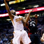 Phoenix Suns' Markieff Morris rebounds over Toronto Raptors'  Bismack Biyombo (8) during the first half of an NBA basketball game, Tuesday, Feb. 2, 2016, in Phoenix. (AP Photo/Matt York)
