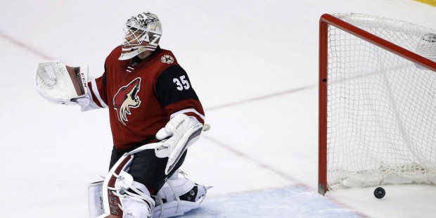 Arizona Coyotes' Louis Domingue gives up a goal to Los Angeles Kings' Dustin Brown during the secon...