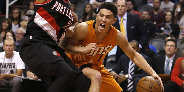 Phoenix Suns guard Devin Booker, right, drives on Portland Trail Blazers forward Allen Crabbe, left...