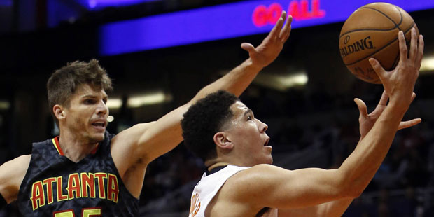 Phoenix Suns guard Devin Booker drives past Atlanta Hawks guard Kyle Korver (26) during the second ...