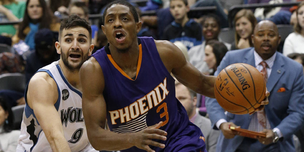 Phoenix Suns guard Brandon Knight (3) drives past Minnesota Timberwolves guard Ricky Rubio (9), of ...