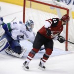 Vancouver Canucks' Ryan Miller (30) gets some help from Alex Biega, left, as they stop a shot by Arizona Coyotes' Kyle Chipchura (24) during the third period of an NHL hockey game Wednesday, Feb. 10, 2016, in Glendale, Ariz. The Canucks defeated the Coyotes 2-1. (AP Photo/Ross D. Franklin)