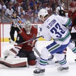Arizona Coyotes' Louis Domingue, left, makes a save on a shot by Vancouver Canucks' Henrik Sedin (33), of Sweden, as Coyotes' Connor Murphy (5) defends during the first period of an NHL hockey game Wednesday, Feb. 10, 2016, in Glendale, Ariz. (AP Photo/Ross D. Franklin)