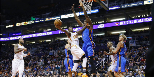 Phoenix Suns' Archie Goodwin tries to get off a shot over Oklahoma City Thunder's Serge Ibaka (9), ...