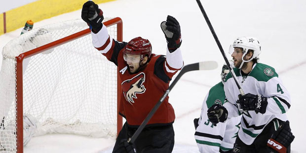 Arizona Coyotes' Martin Hanzal, left, of the Czech Republic, and Oliver Ekman-Larsson, bottom right...