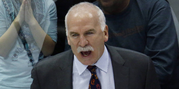 Chicago Blackhawks head coach Joel Quenneville, top, directs his team against the Colorado Avalanch...