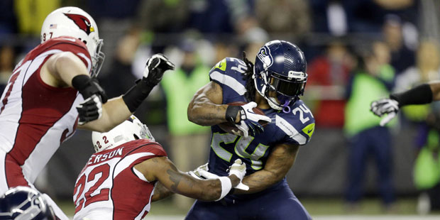 Seattle Seahawks running back Marshawn Lynch (24) rushes as Arizona Cardinals strong safety Tony Je...