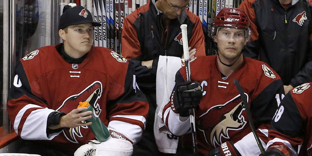 Arizona Coyotes backup goalie Nathan Schoenfeld, left, signed to the team only hours prior to the g...